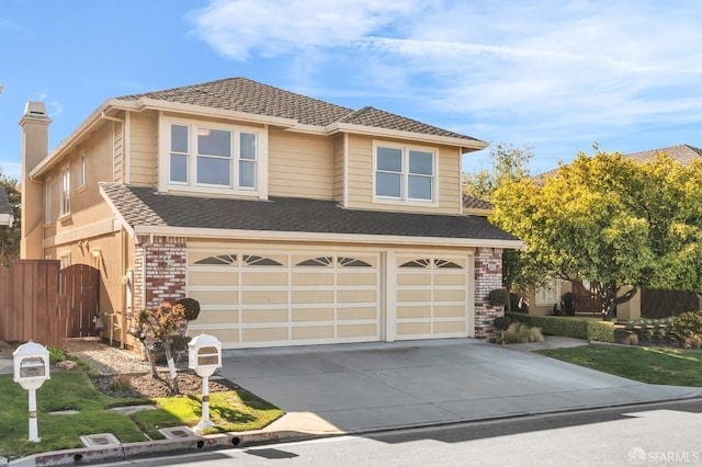 traditional home featuring driveway, roof with shingles, a garage, brick siding, and a chimney