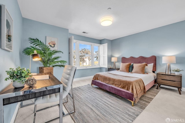 carpeted bedroom featuring visible vents and baseboards