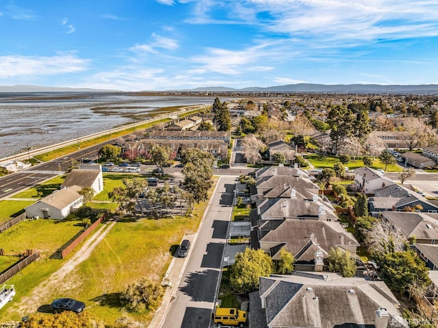 drone / aerial view with a residential view and a water and mountain view