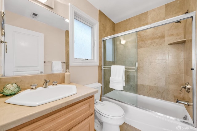 bathroom with visible vents, enclosed tub / shower combo, toilet, and vanity