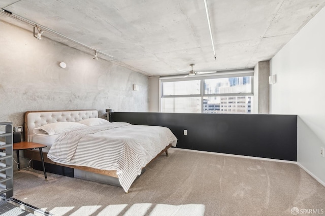 bedroom featuring carpet floors and rail lighting