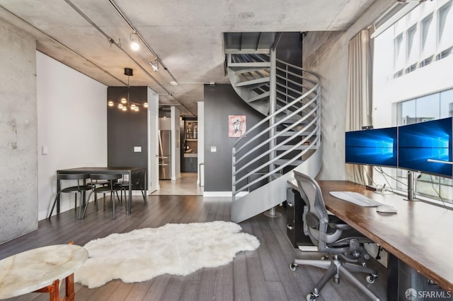 office space with dark wood-type flooring and rail lighting