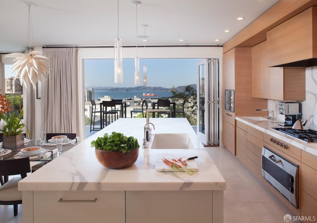 1970 Jackson St, San Francisco, CA 94109 - kitchen with modern cabinets, oven, stainless steel gas stovetop, a kitchen island with sink, and a sink