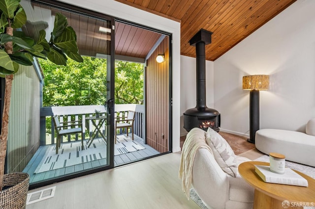 229 Cypress Point Dr, Mountain View, CA 94043 - doorway to outside with plenty of natural light, a wood stove, wood finished floors, wooden ceiling, and lofted ceiling