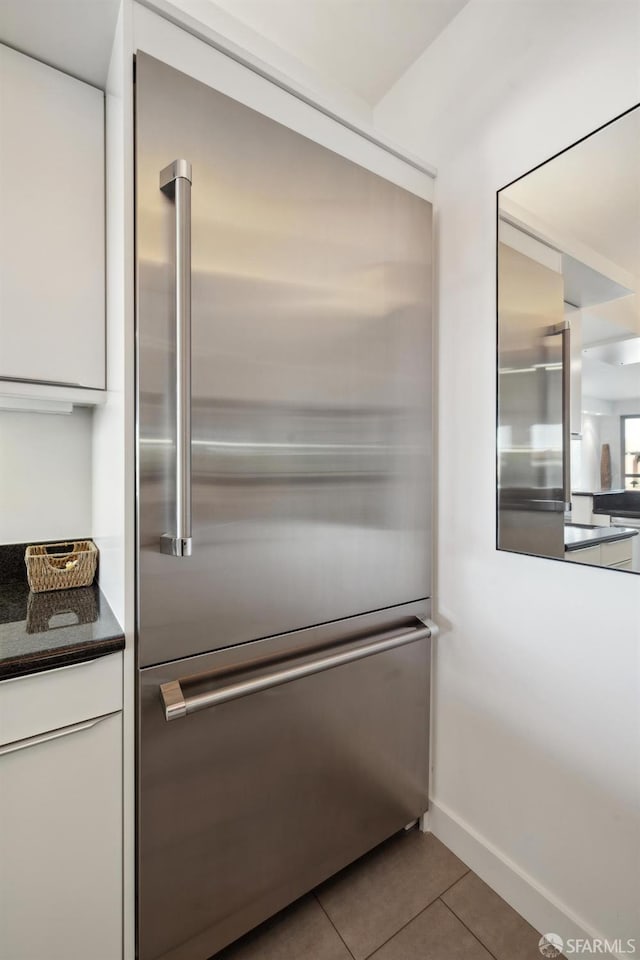 interior details with white cabinets and stainless steel built in fridge