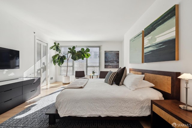 bedroom with hardwood / wood-style flooring