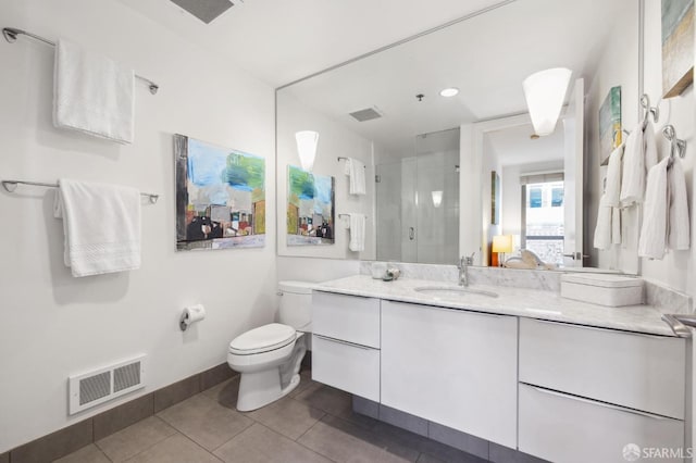 bathroom with tile patterned flooring, vanity, toilet, and an enclosed shower