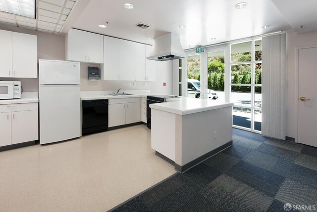 kitchen featuring light countertops, island range hood, a sink, black appliances, and white cabinetry