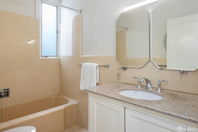 bathroom featuring shower / bathtub combination, vanity, and tile walls