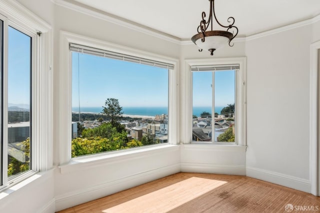 unfurnished sunroom with a water view and a notable chandelier