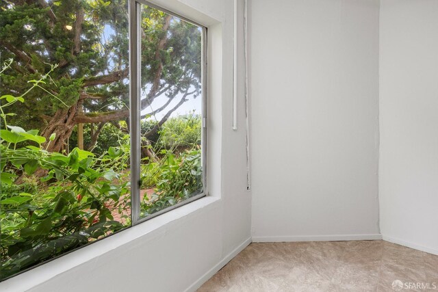 spare room with plenty of natural light and baseboards