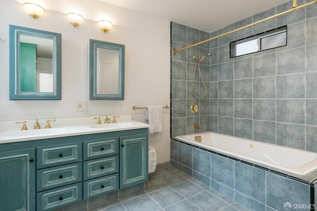 full bath featuring double vanity, a sink, tiled shower / bath combo, and tile patterned floors