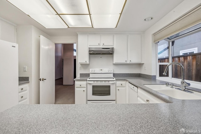 kitchen featuring white appliances, white cabinets, under cabinet range hood, and a sink