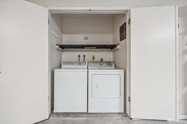 clothes washing area with separate washer and dryer