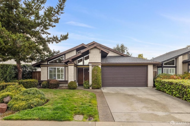 mid-century modern home with a front lawn, an attached garage, and driveway