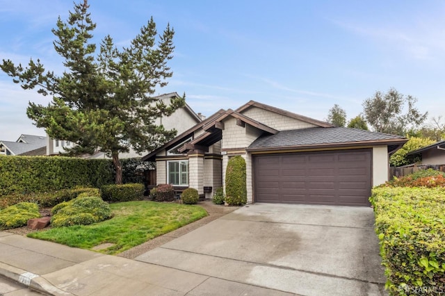 view of front of property with driveway, an attached garage, and fence