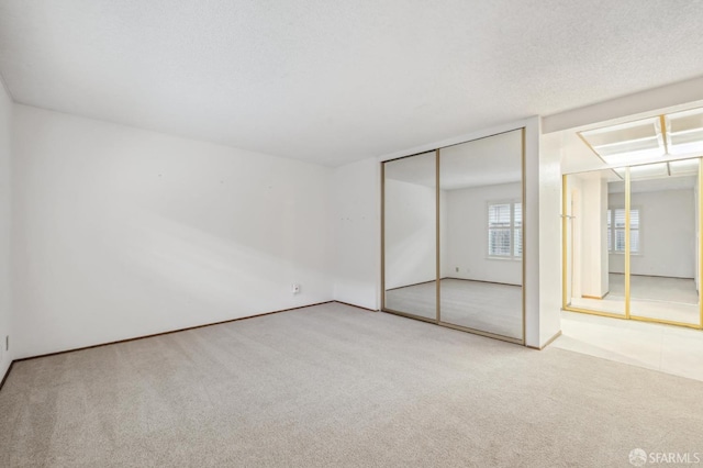 unfurnished bedroom featuring carpet and a textured ceiling