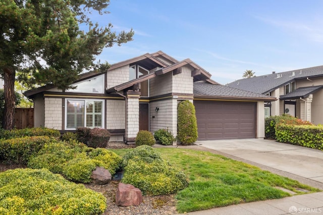 mid-century home featuring driveway and a garage