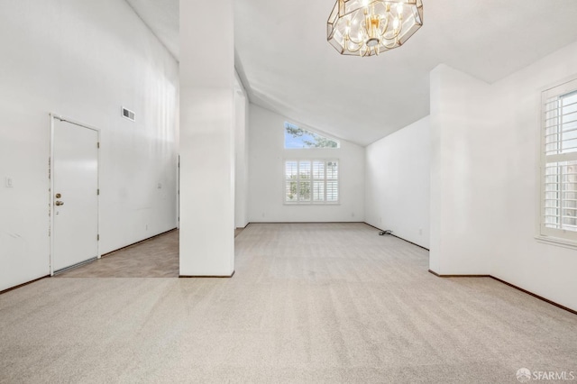 interior space with visible vents, high vaulted ceiling, an inviting chandelier, and carpet flooring