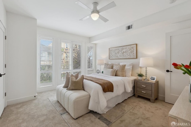 bedroom with baseboards, a ceiling fan, light colored carpet, and visible vents