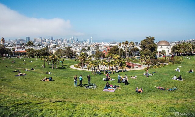 view of home's community with a yard and a view of city