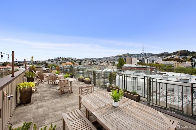 wooden terrace with a patio and outdoor dining area
