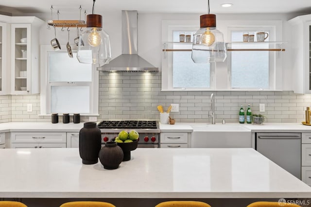 4145 Emerald St, Oakland, CA 94609 - kitchen featuring wall chimney exhaust hood, white cabinetry, light countertops, appliances with stainless steel finishes, and backsplash