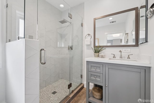 4145 Emerald St, Oakland, CA 94609 - bathroom with vanity, a stall shower, wood finished floors, and recessed lighting