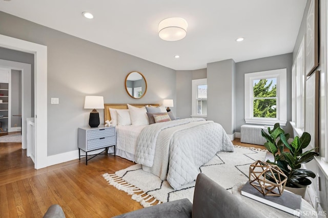 4145 Emerald St, Oakland, CA 94609 - bedroom featuring radiator heating unit, wood finished floors, and recessed lighting