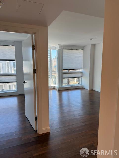 555 Fulton St Unit 322, San Francisco, CA 94102 - corridor featuring dark wood-style flooring and baseboards