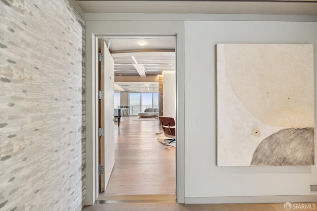 hall featuring beam ceiling and hardwood / wood-style flooring