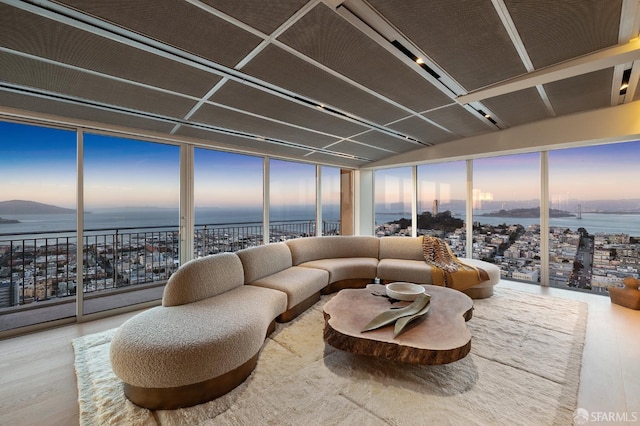 sunroom / solarium featuring a water view