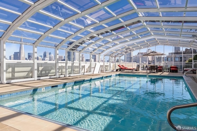 view of swimming pool with a lanai and a patio area