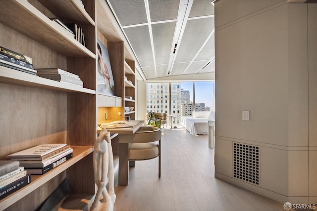 interior space featuring expansive windows and light wood-type flooring