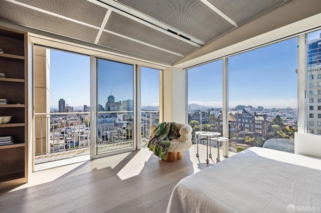 bedroom featuring hardwood / wood-style floors and multiple windows