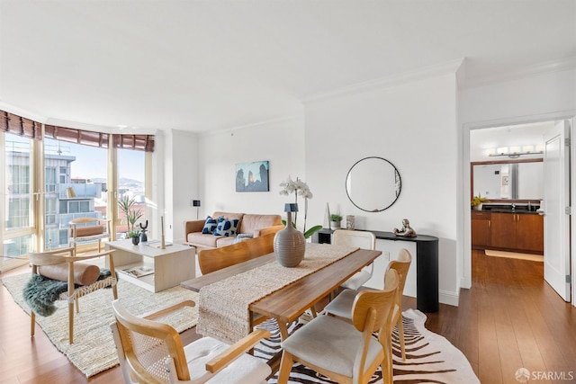 living room featuring expansive windows, crown molding, and wood-type flooring