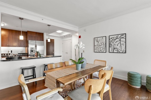 dining area with crown molding and dark wood-type flooring