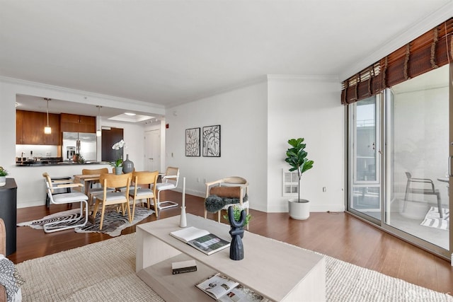 living room with wood-type flooring and ornamental molding