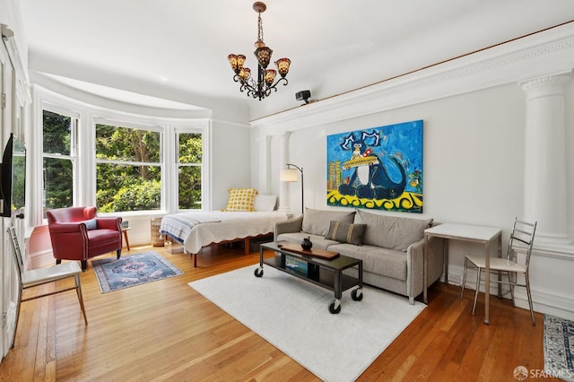 1932 Fell St Unit 1, San Francisco, CA 94117 - bedroom featuring a chandelier, wood finished floors, and ornate columns