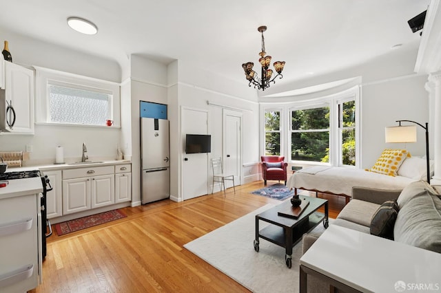 1932 Fell St Unit 1, San Francisco, CA 94117 - living area featuring light wood-style flooring, healthy amount of natural light, and a chandelier