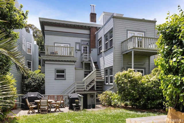 1932 Fell St Unit 1, San Francisco, CA 94117 - rear view of property with a balcony, a patio, and a chimney