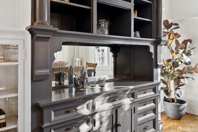 bar with hardwood / wood-style floors