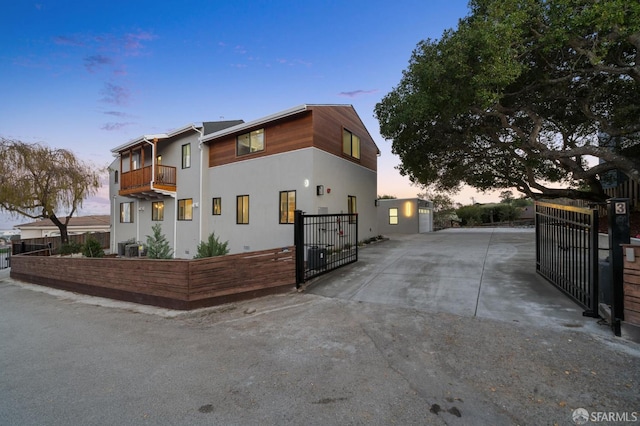 property exterior at dusk with a balcony