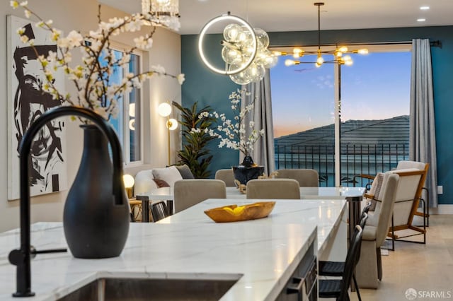 dining space featuring an inviting chandelier and sink