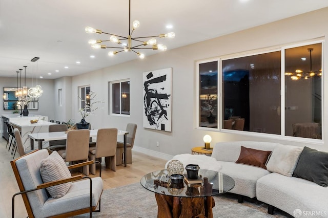 living room with an inviting chandelier and light hardwood / wood-style floors