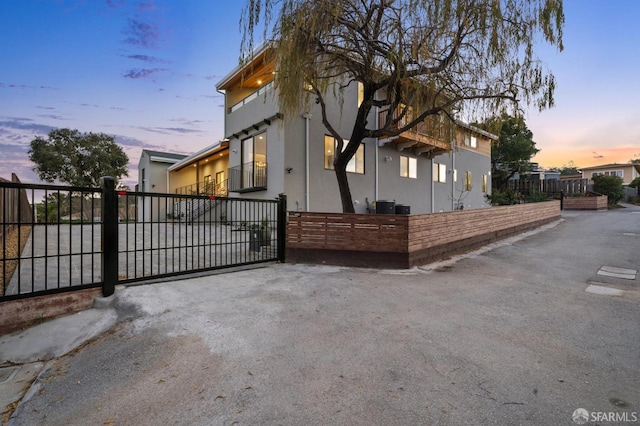 property exterior at dusk with a balcony