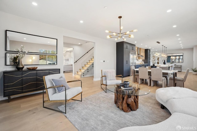 living room featuring a notable chandelier and light hardwood / wood-style flooring