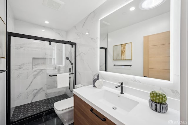 bathroom featuring vanity, toilet, and a shower with shower door