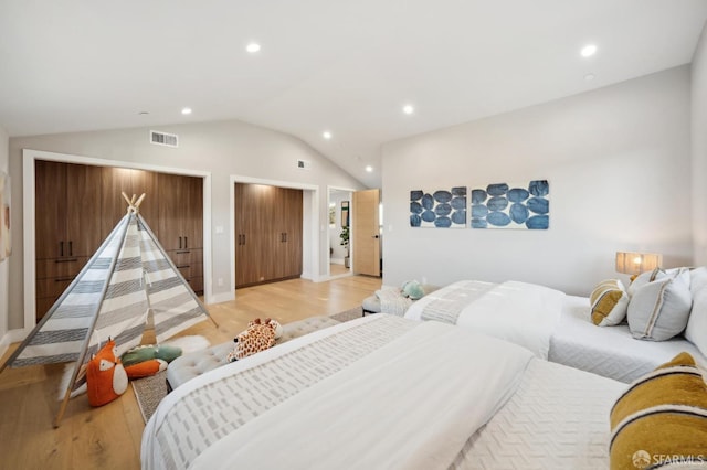 bedroom featuring vaulted ceiling and light hardwood / wood-style flooring