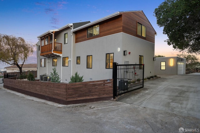 view of front of home with a garage and a balcony